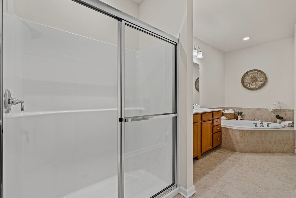 36 Abigail Way, Unit 3009 Reading, MA 01867 - Photo 22 of 36 a bathroom with a tub sink mirror and vanity
