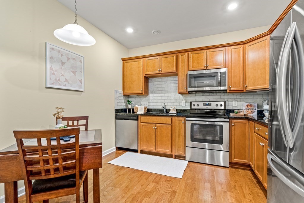 36 Abigail Way, Unit 3009 Reading, MA 01867 - Photo 5 of 36 a kitchen with stainless steel appliances a stove a sink and a microwave