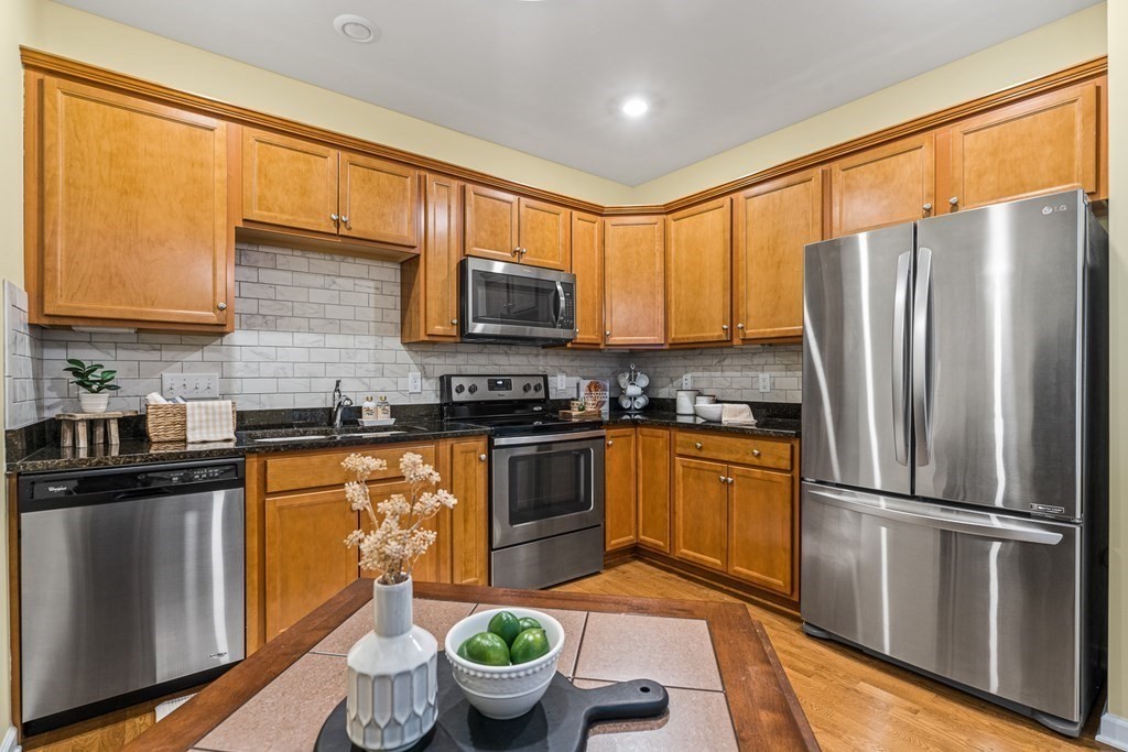 36 Abigail Way, Unit 3009 Reading, MA 01867 - Photo 6 of 36 a kitchen with stainless steel appliances a refrigerator stove microwave and sink