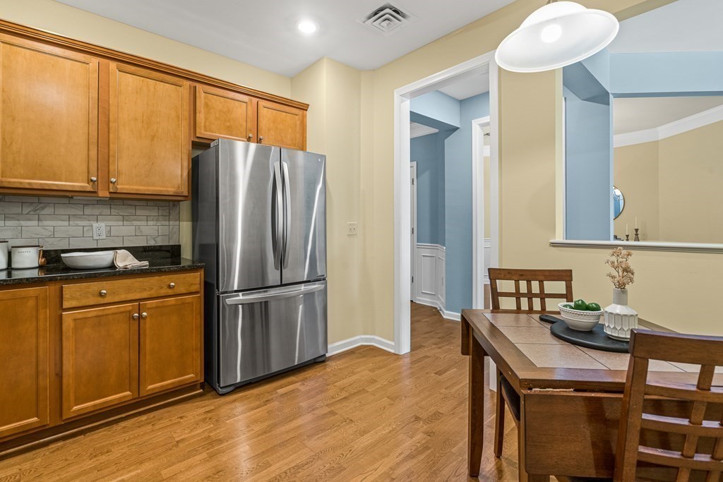 36 Abigail Way, Unit 3009 Reading, MA 01867 - Photo 7 of 36 a kitchen with stainless steel appliances granite countertop a refrigerator and a stove top oven