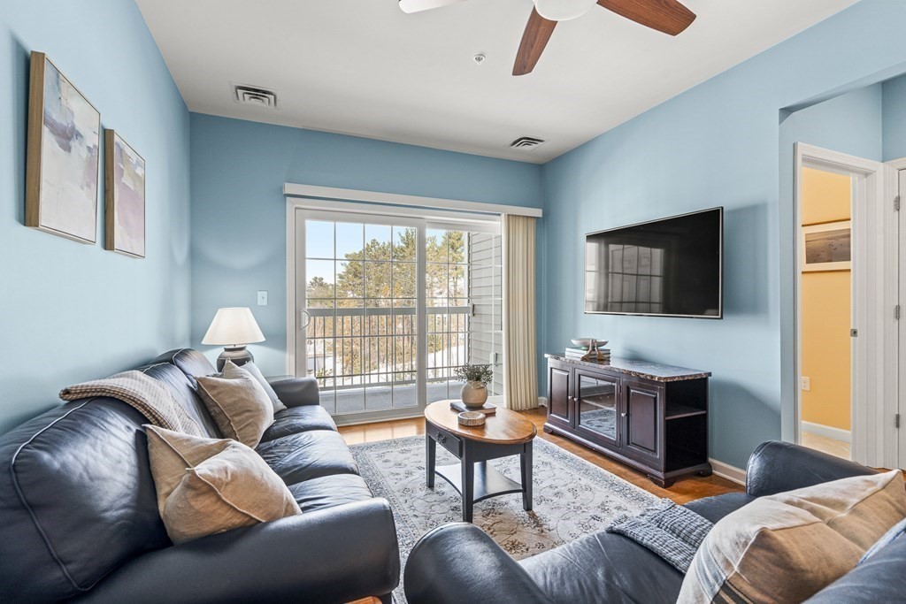 36 Abigail Way, Unit 3009 Reading, MA 01867 - Photo 10 of 36 a living room with furniture and a flat screen tv