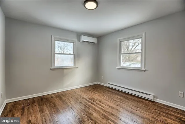 a view of a room with wooden floor and windows