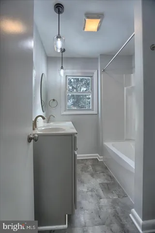 a bathroom with a sink a mirror and a bathtub