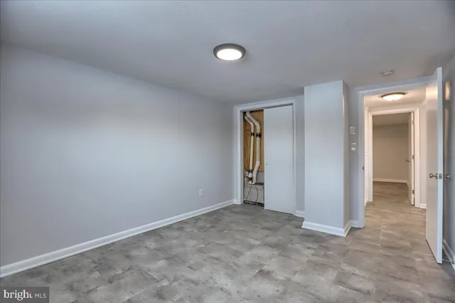 an empty room with closet and a window