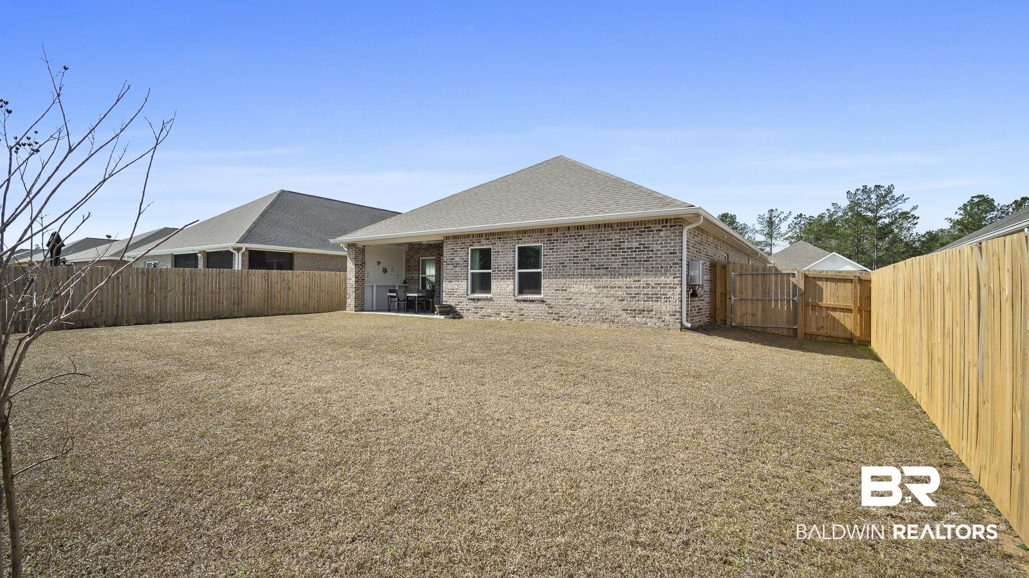 13887 Antler Hl Road Daphne, AL 36527 - Photo 27 of 50 Back of property with a gate, a patio, brick siding, a fenced backyard, and a shingled roof