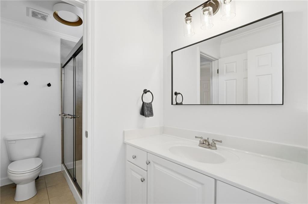 1810 Kilough Church Road Dawsonville, GA 30534 - Photo 17 of 29 a bathroom with a toilet sink a mirror and vanity
