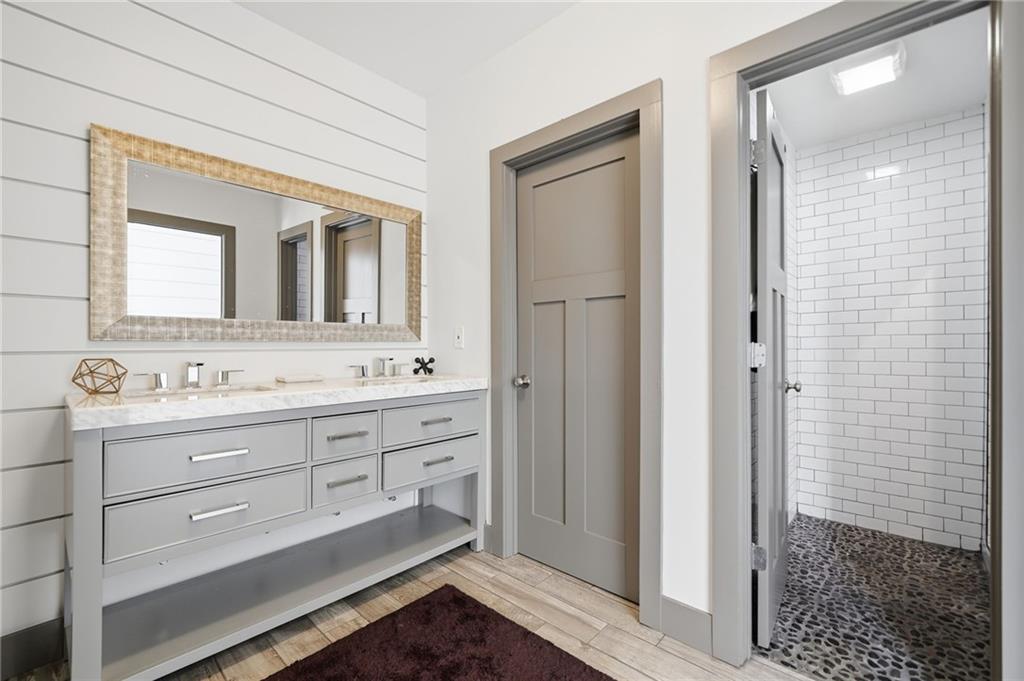 1810 Kilough Church Road Dawsonville, GA 30534 - Photo 20 of 29 a bathroom with a granite countertop sink mirror and shower