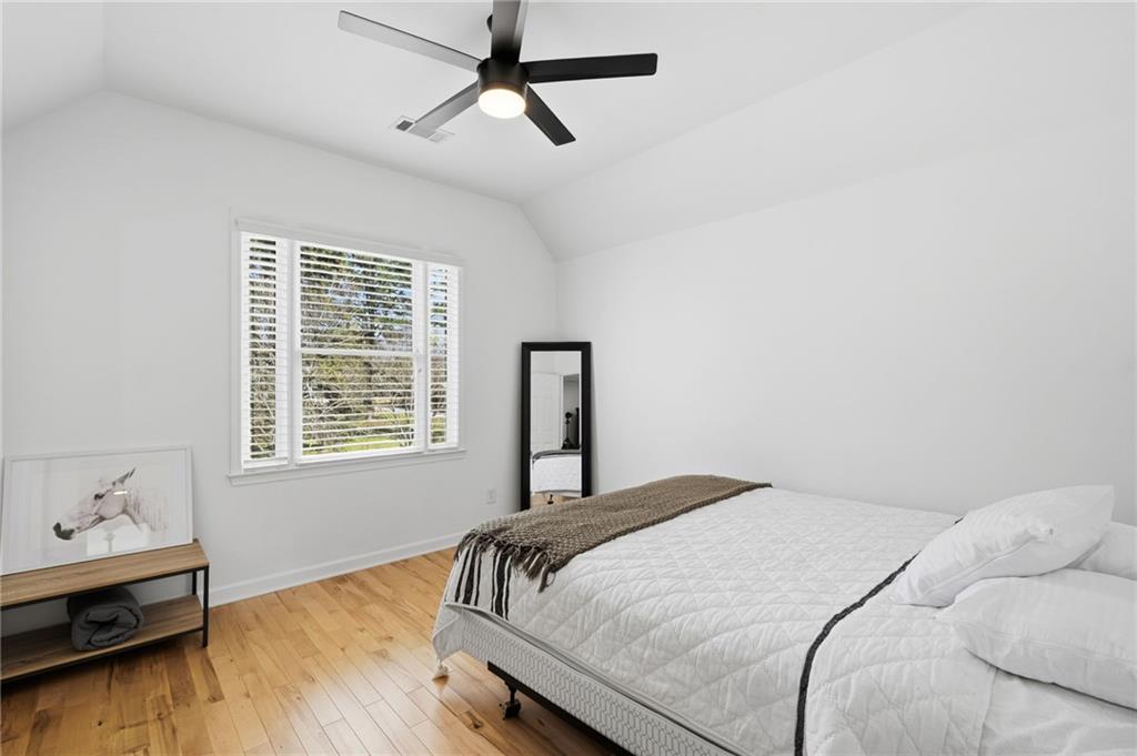 1810 Kilough Church Road Dawsonville, GA 30534 - Photo 25 of 29 a bedroom with a bed and wooden floor