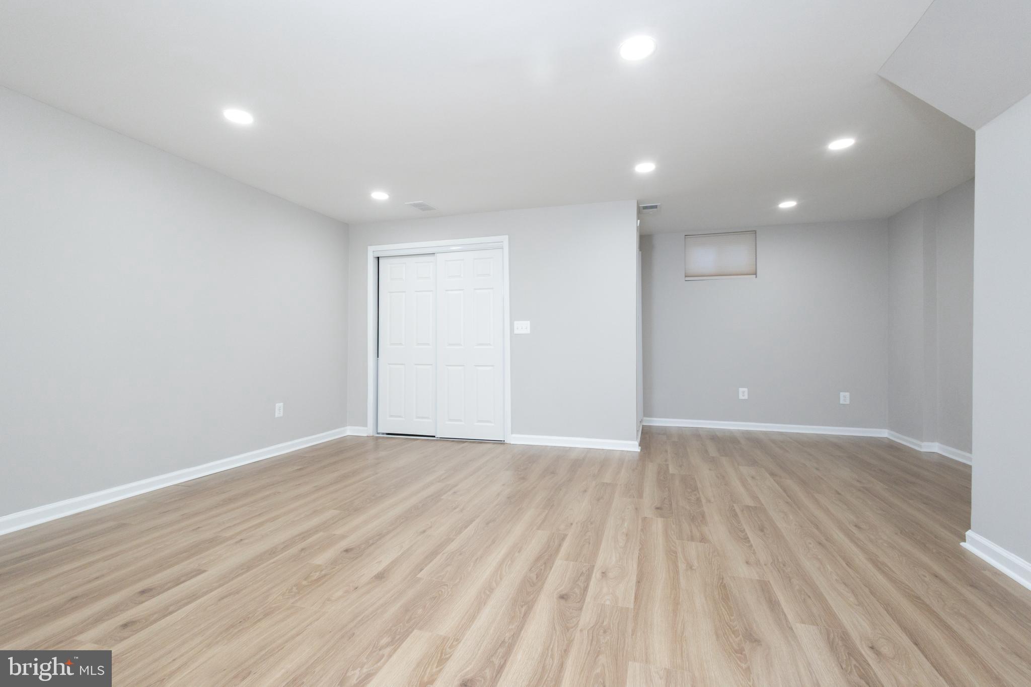 8058 Felecity Court Springfield, VA 22153 - Photo 13 of 35 a view of an empty room with wooden floor and entryway