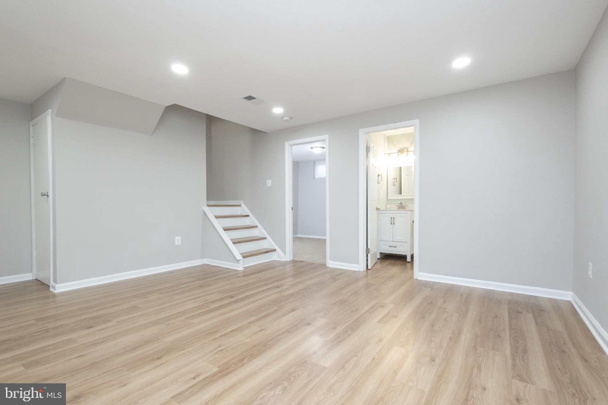 8058 Felecity Court Springfield, VA 22153 - Photo 15 of 35 a view of an empty room with wooden floor and entryway