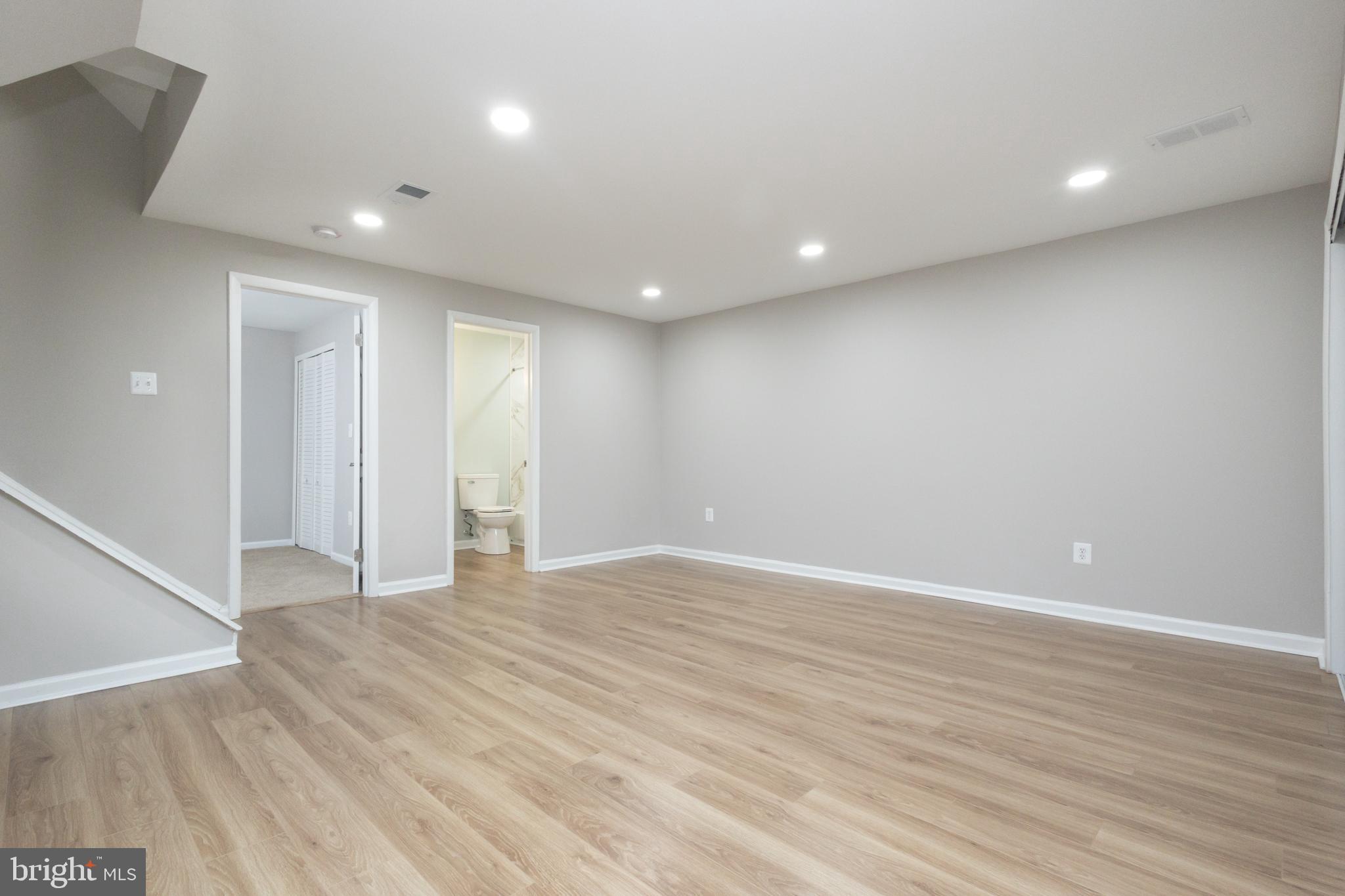 8058 Felecity Court Springfield, VA 22153 - Photo 16 of 35 a view of an empty room with wooden floor