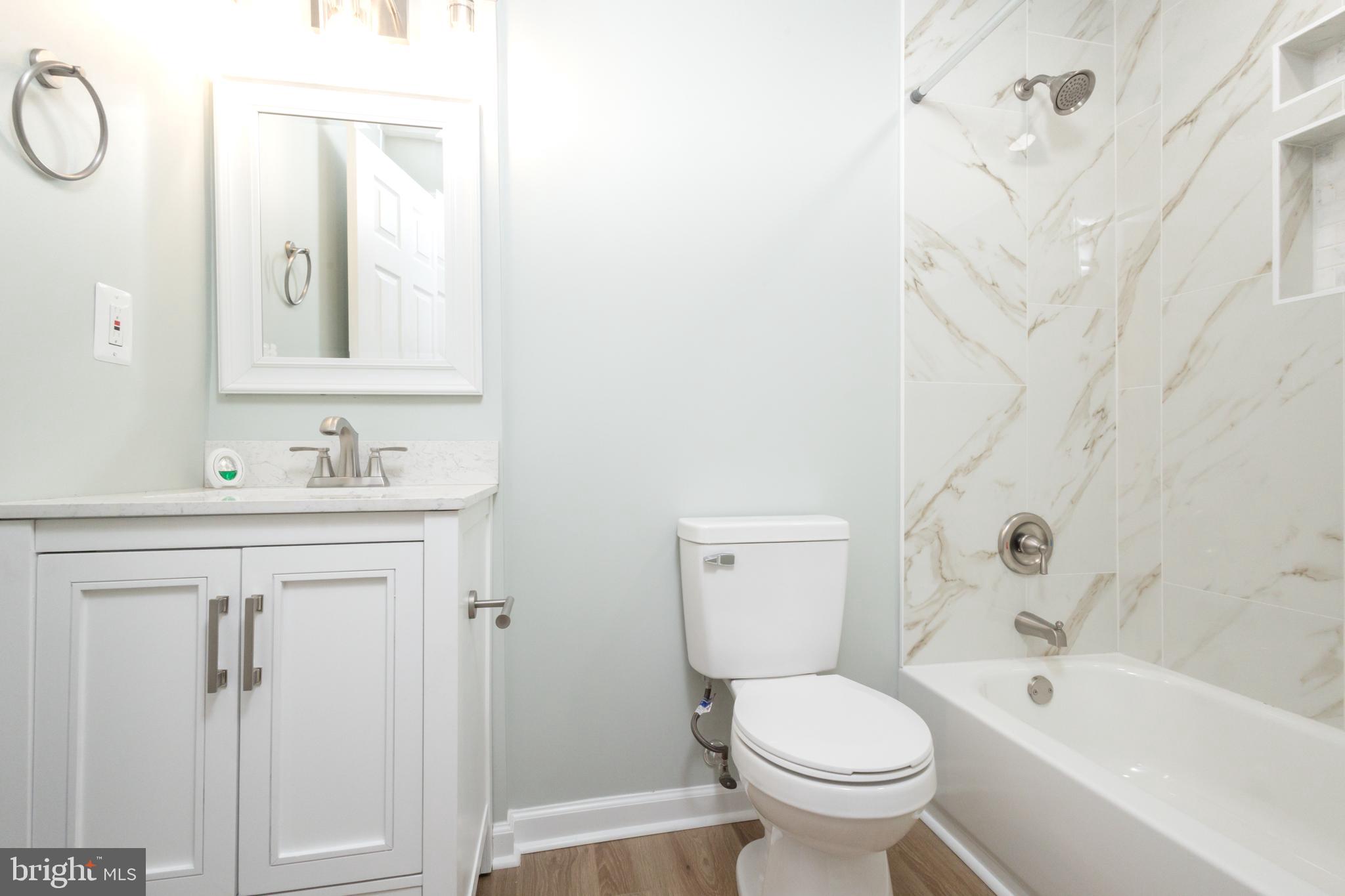 8058 Felecity Court Springfield, VA 22153 - Photo 18 of 35 a bathroom with a sink toilet and shower
