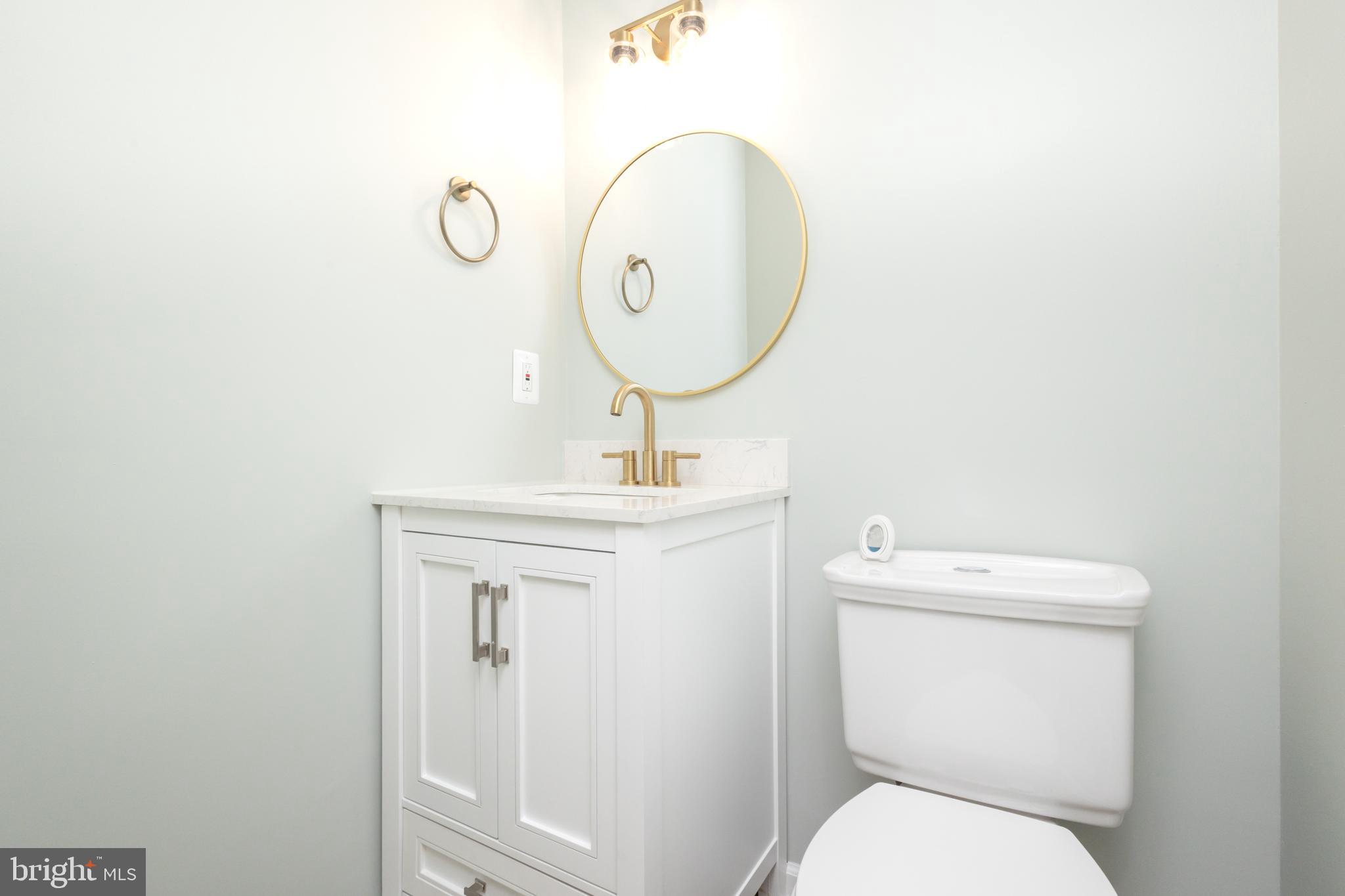 8058 Felecity Court Springfield, VA 22153 - Photo 5 of 35 a bathroom with a toilet a sink and mirror