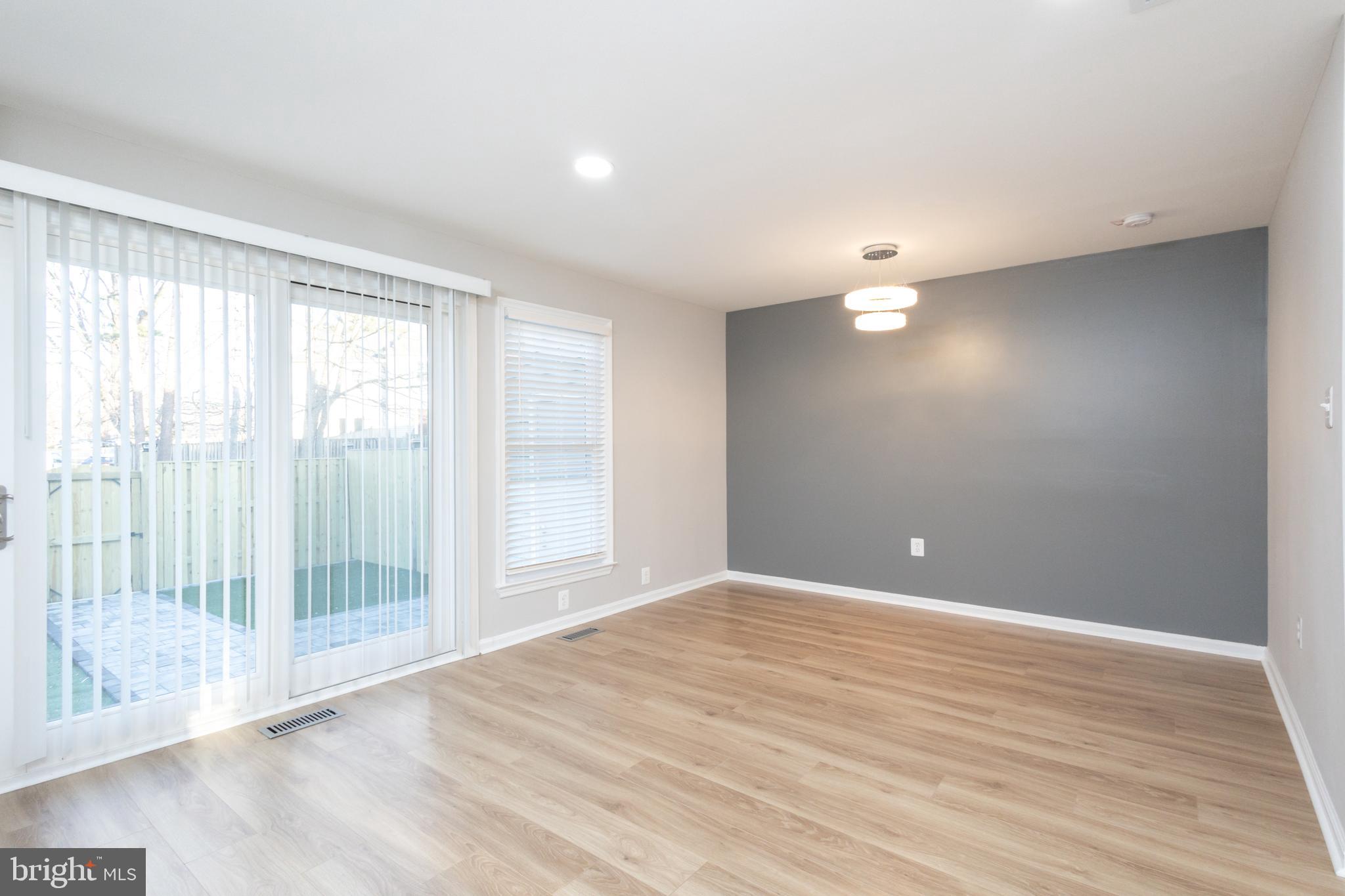 8058 Felecity Court Springfield, VA 22153 - Photo 9 of 35 a view of an empty room with wooden floor and a window