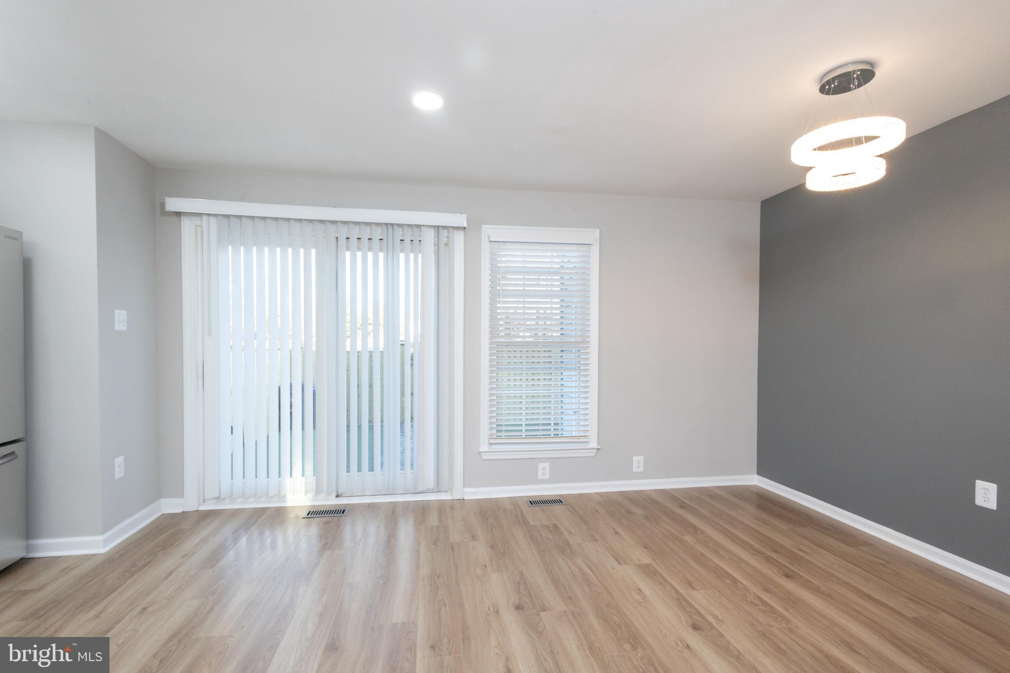 8058 Felecity Court Springfield, VA 22153 - Photo 10 of 35 an empty room with wooden floor and windows