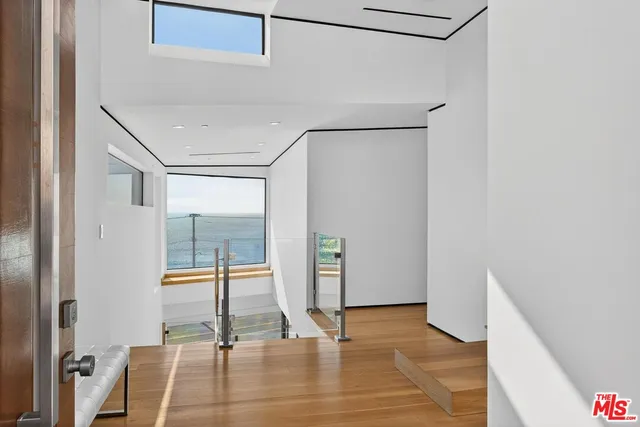 a bedroom with a bed and a potted plant on the wall