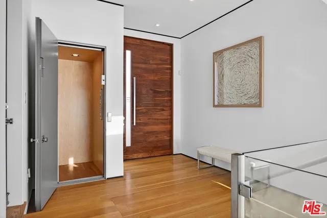 a view of a patio with table and chairs potted plants and a palm tree