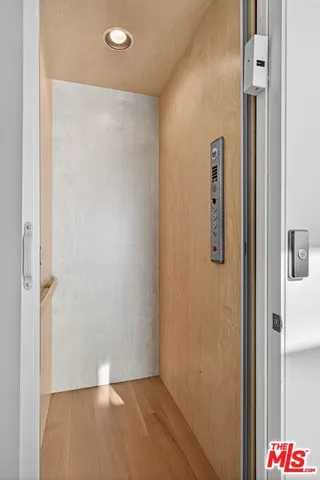 a view of a patio with couches and a potted plant on a table