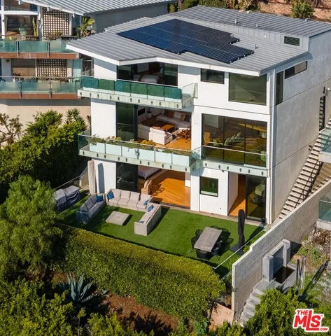 a bathroom with a granite countertop sink a mirror and shower