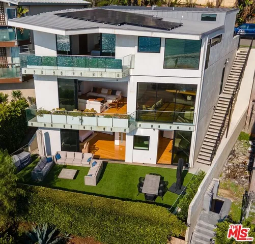 a bathroom with a granite countertop sink a mirror and bathtub