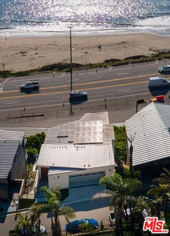 a living room with furniture a chandelier and a flat screen tv