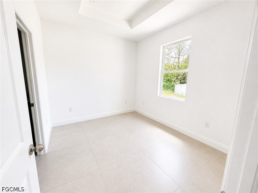 8753 Buckingham Road Lehigh Acres, FL 33971 - Photo 9 of 13 an empty room with windows