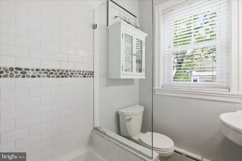 a white toilet sitting next to a bathroom sink