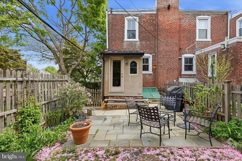 a view of a patio with table and chairs and potted plants