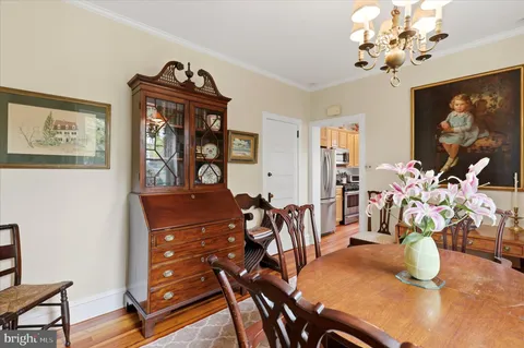 a view of a dining room with furniture and chandelier