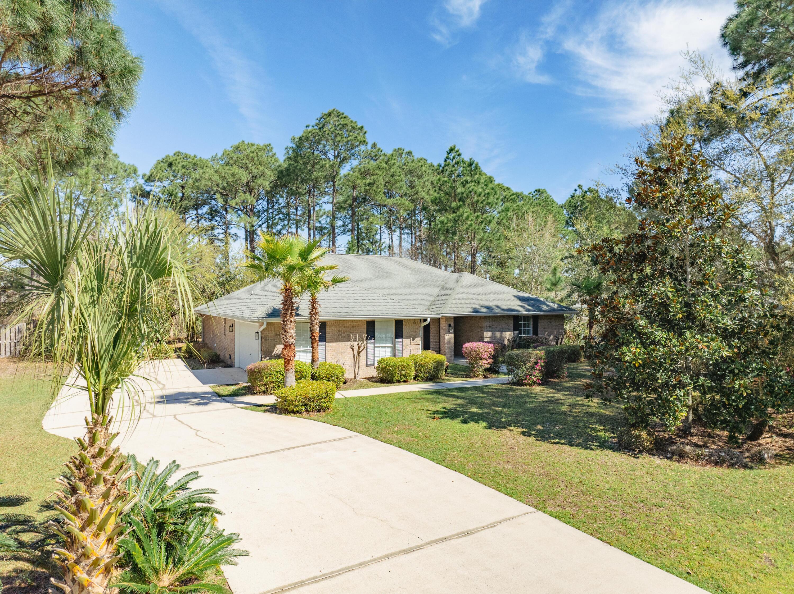 284 Shipwreck Road Santa Rosa Beach, FL 32459 - Photo 2 of 43 a view of a house with a yard and tree s