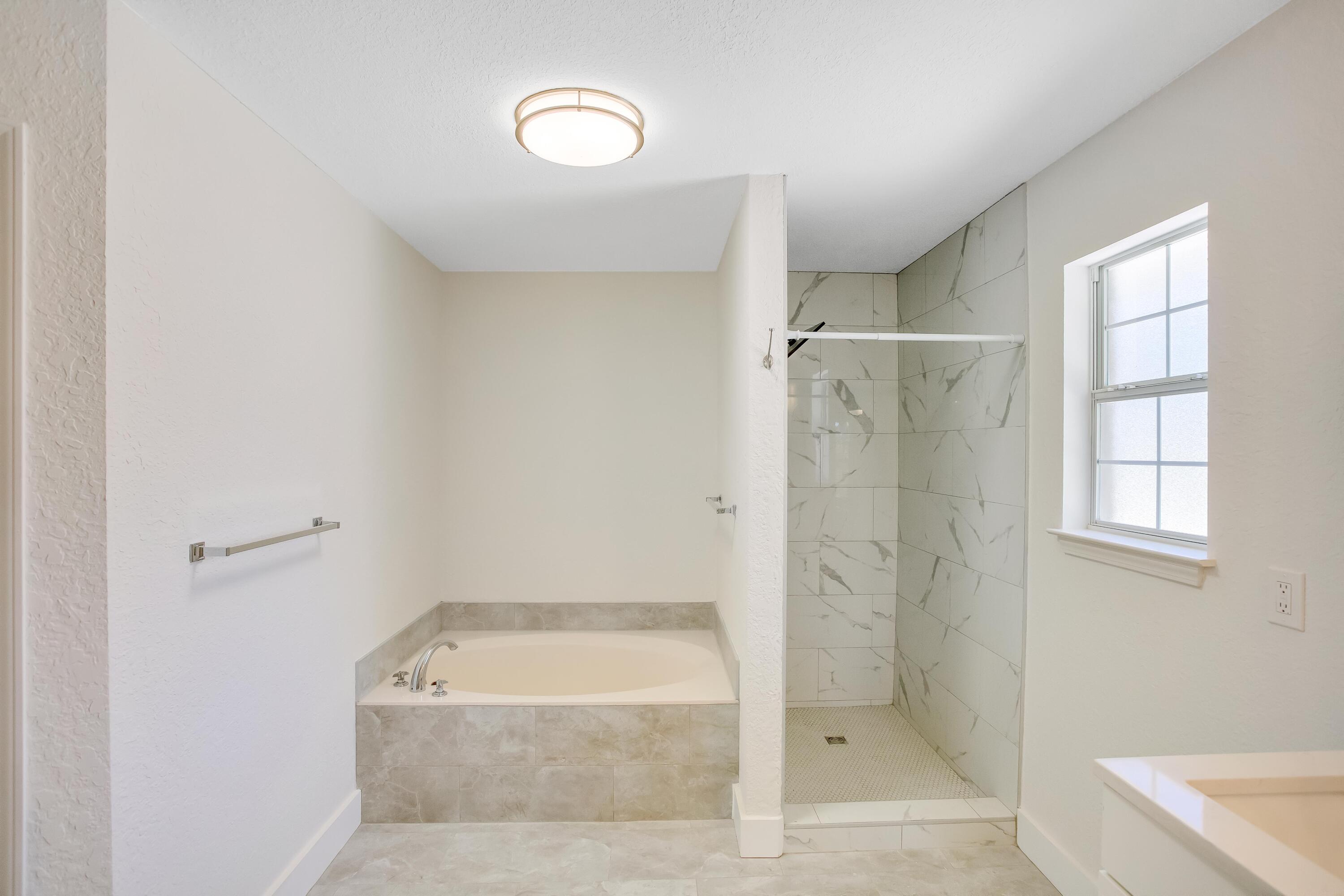 284 Shipwreck Road Santa Rosa Beach, FL 32459 - Photo 21 of 43 a bathroom with a tub shower and window