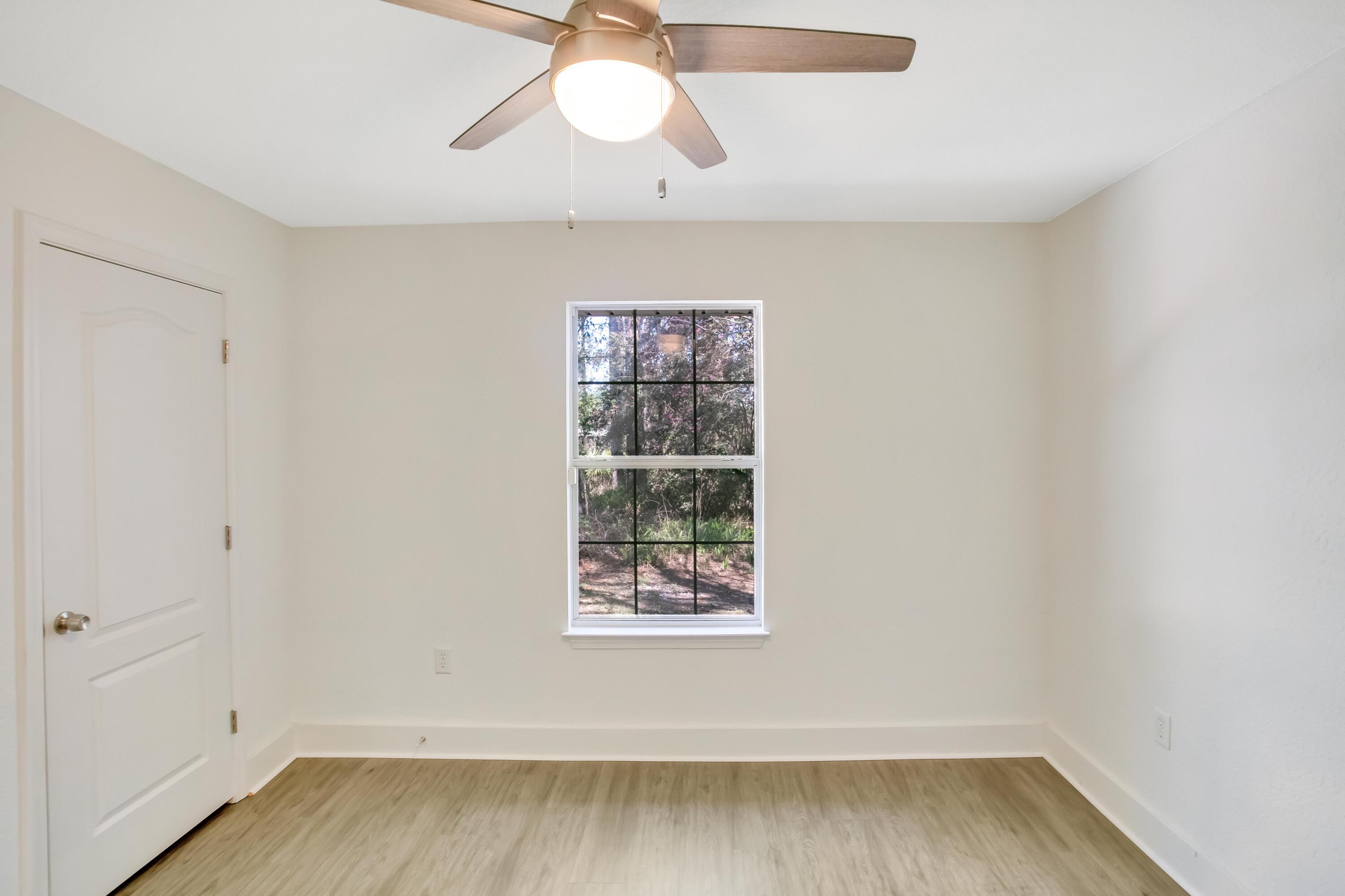 284 Shipwreck Road Santa Rosa Beach, FL 32459 - Photo 23 of 43 an empty room with a window and wooden floor