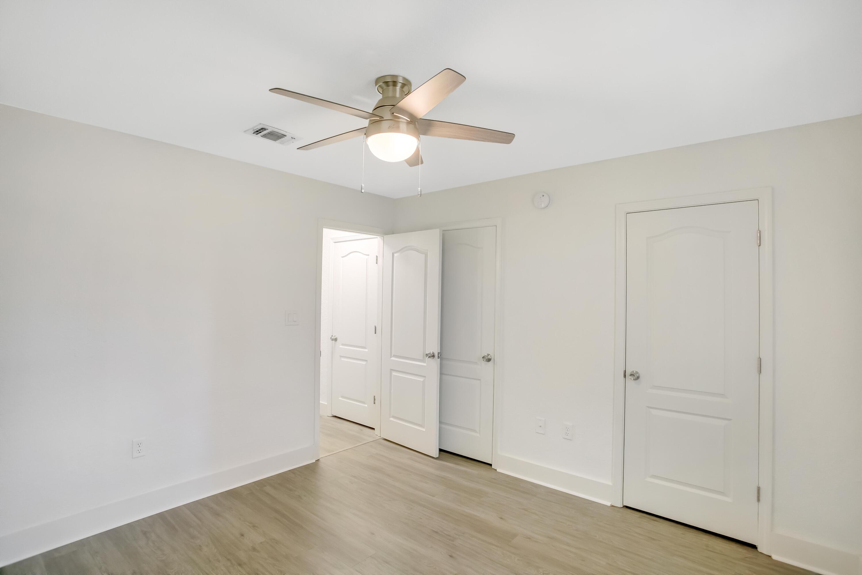 284 Shipwreck Road Santa Rosa Beach, FL 32459 - Photo 24 of 43 an empty room with wooden floor fan and windows