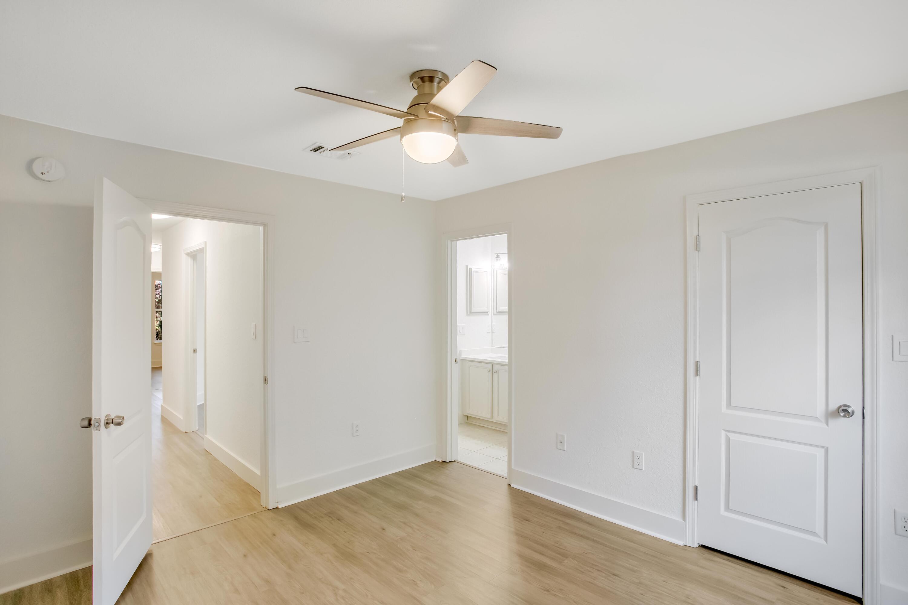 284 Shipwreck Road Santa Rosa Beach, FL 32459 - Photo 29 of 43 an empty room with wooden floor fan and windows