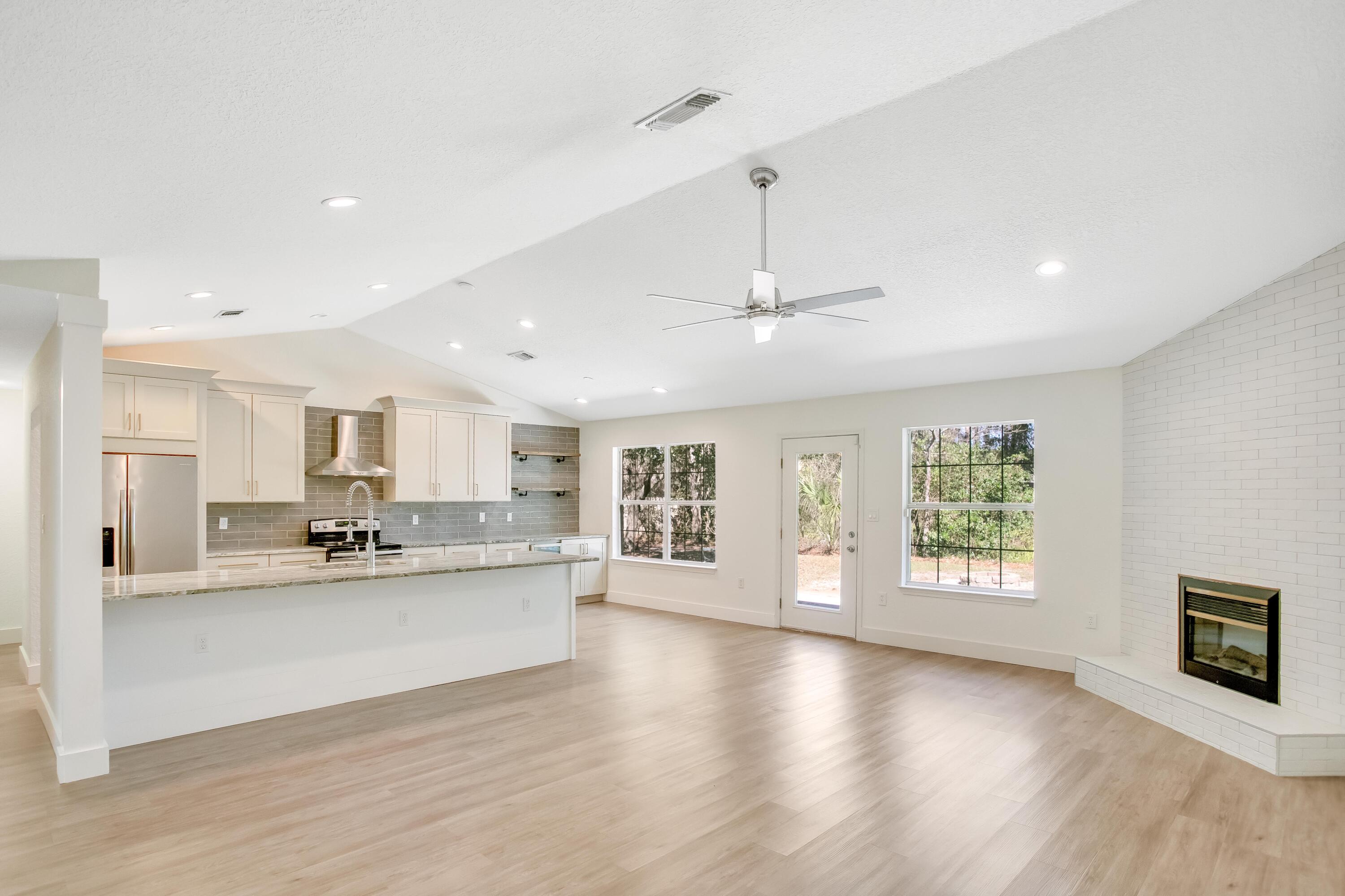 284 Shipwreck Road Santa Rosa Beach, FL 32459 - Photo 6 of 43 a large kitchen with kitchen island a sink stainless steel appliances and cabinets