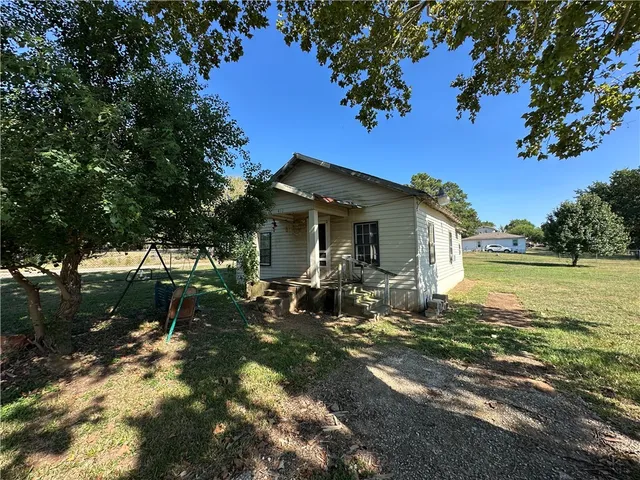 a view of a house with backyard porch and sitting area