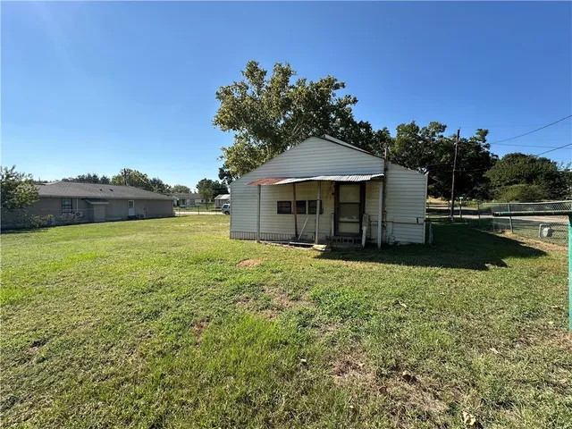 a backyard of a house with table and chairs