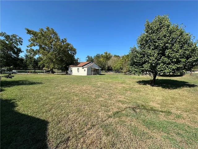 a view of a field with an trees