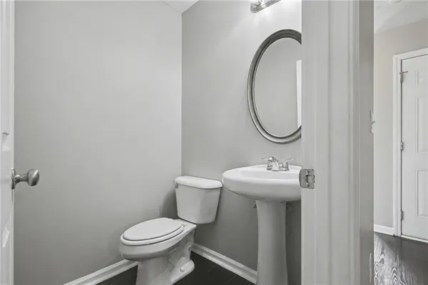 a bathroom with a sink toilet and a mirror