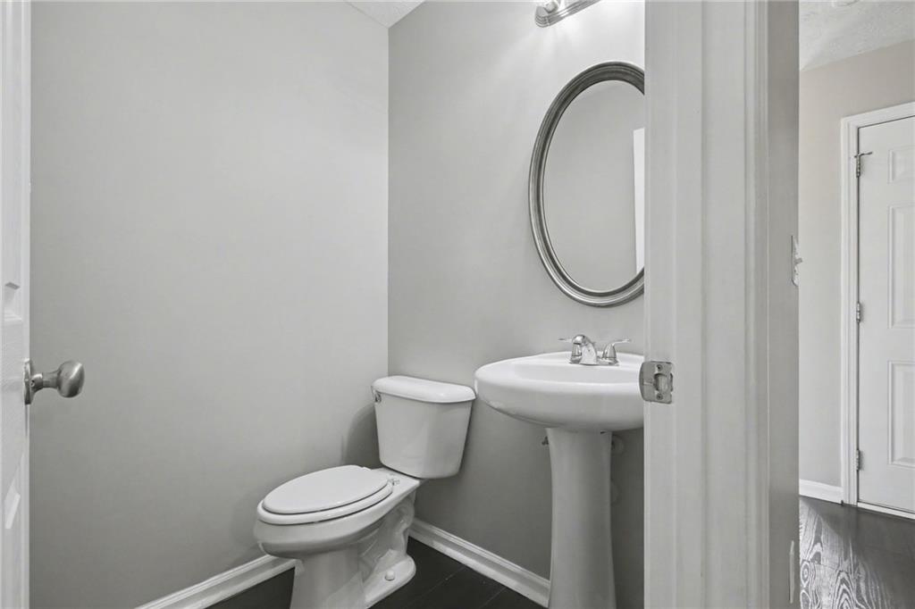 1259 Maxey Court Winder, GA 30680 - Photo 12 of 30 a bathroom with a sink toilet and a mirror