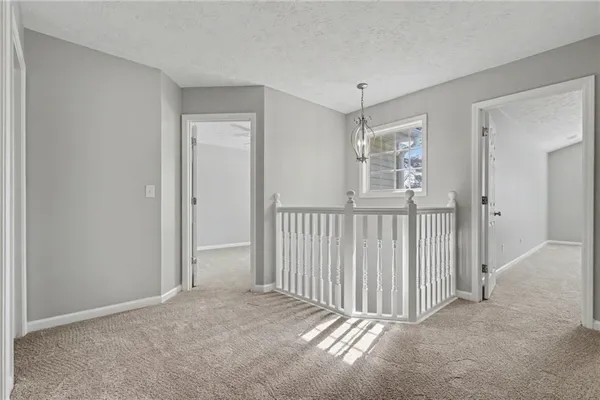 a view of a hallway with a window and stairs