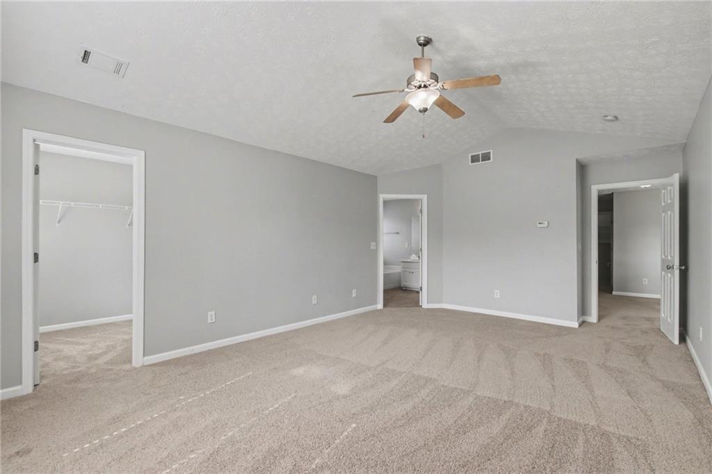 1259 Maxey Court Winder, GA 30680 - Photo 16 of 30 a view of an empty room with a chandelier fan