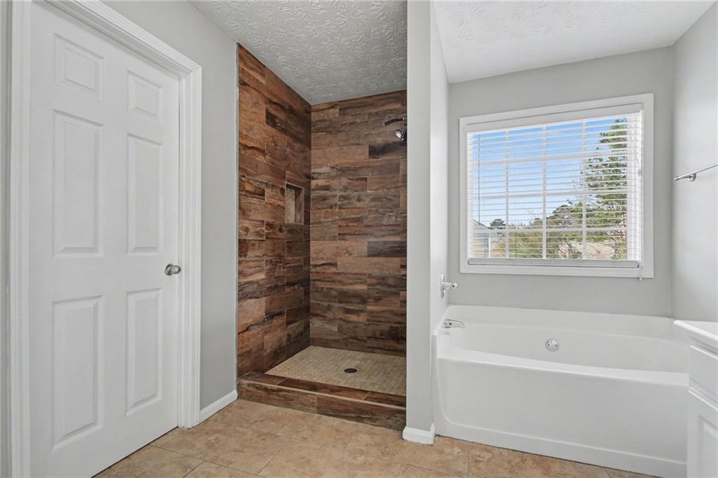 1259 Maxey Court Winder, GA 30680 - Photo 18 of 30 a bathroom with bathtub and shower