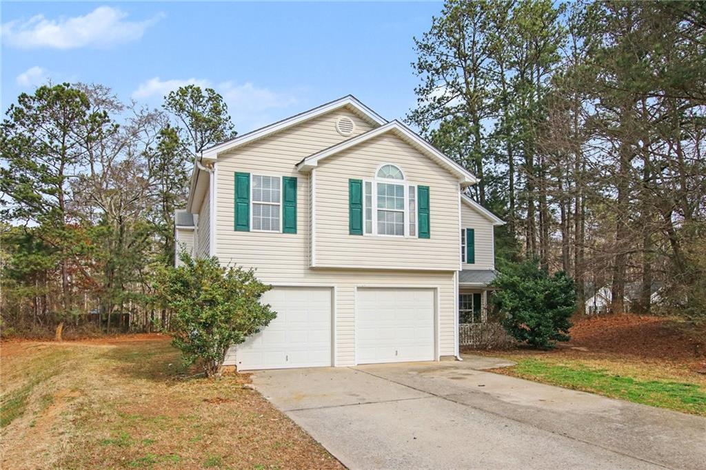1259 Maxey Court Winder, GA 30680 - Photo 2 of 30 a view of a white house with a yard and large tree