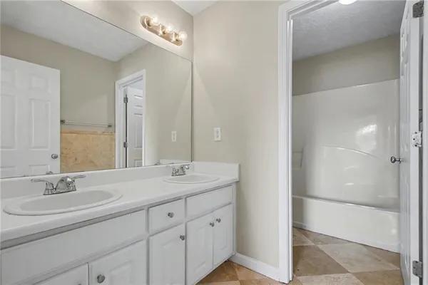 a bathroom with a double vanity sink and a mirror
