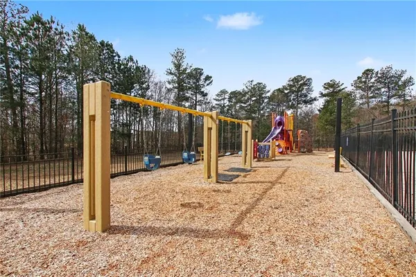 a view of a park with swings and slides