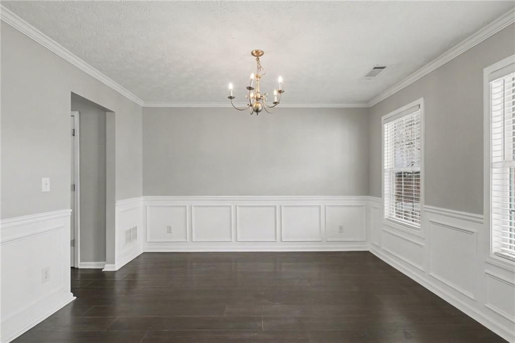1259 Maxey Court Winder, GA 30680 - Photo 4 of 30 an empty room with wooden floor cabinet and windows