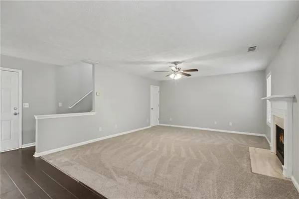 wooden floor in an empty room with a fireplace