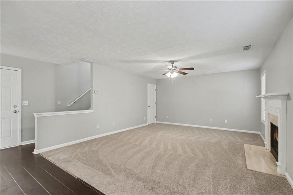 1259 Maxey Court Winder, GA 30680 - Photo 6 of 30 wooden floor in an empty room with a fireplace