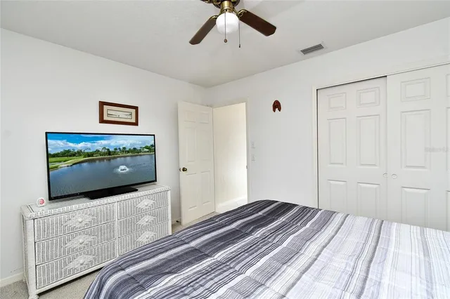 a bedroom with bed and flat screen tv